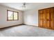 This bedroom is a blank canvas with neutral carpeting, a double closet, and a window at 1510 Continental Dr, Zionsville, IN 46077