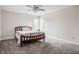 A cozy bedroom featuring a bed with neutral bedding, plush carpet, and a ceiling fan for added comfort at 1510 Continental Dr, Zionsville, IN 46077
