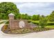 Community entrance sign surrounded by colorful flowers and trees, next to a pond at 1510 Continental Dr, Zionsville, IN 46077