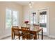 Inviting dining room featuring a wooden table, bright window, and access to the outdoor area at 1510 Continental Dr, Zionsville, IN 46077