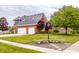 Beautiful two-story brick home with a three-car garage and manicured landscaping at 1510 Continental Dr, Zionsville, IN 46077