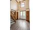 Grand foyer with hardwood floors, staircase, and natural light from a large window at 1510 Continental Dr, Zionsville, IN 46077