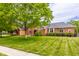 Well-maintained two-story brick home featuring lush green lawn and mature trees at 1510 Continental Dr, Zionsville, IN 46077