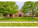 Charming two-story brick home with mature trees and a well-manicured lawn at 1510 Continental Dr, Zionsville, IN 46077