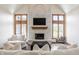 Comfortable living room with a cozy fireplace, hardwood floors, and modern furnishings at 1510 Continental Dr, Zionsville, IN 46077