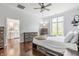Stylish main bedroom with a ceiling fan, wood floors, and serene view to the bathroom at 1510 Continental Dr, Zionsville, IN 46077