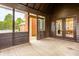 Spacious screened porch showcasing wood floors, access doors, and a peek into the living space at 1510 Continental Dr, Zionsville, IN 46077