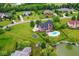 Expansive aerial view of a brick home with a backyard pool and beautifully landscaped yard at 16285 Remington Dr, Fishers, IN 46037