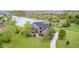 An aerial view of the beautiful brick home with water view and stunning landscaping at 16285 Remington Dr, Fishers, IN 46037