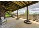 Back patio with a stone fire pit feature and concrete steps leading to a green lawn at 16285 Remington Dr, Fishers, IN 46037