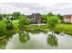 Beautiful backyard with in-ground pool, large pond, lush greenery, and mature trees create a private oasis at 16285 Remington Dr, Fishers, IN 46037