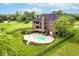Expansive backyard features a sparkling swimming pool, lush lawn, and mature trees, perfect for outdoor enjoyment at 16285 Remington Dr, Fishers, IN 46037
