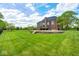 Lush backyard featuring a well-manicured lawn and mature trees providing privacy and shade at 16285 Remington Dr, Fishers, IN 46037