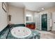 Luxurious bathroom featuring a soaking tub, glass block shower, and stylish vanity with ample counter space at 16285 Remington Dr, Fishers, IN 46037