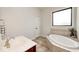 Bright bathroom with soaking tub, tile accents, and a large window at 16285 Remington Dr, Fishers, IN 46037