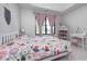 Bright bedroom with a white bed frame, pink curtains, and a large window with view at 16285 Remington Dr, Fishers, IN 46037