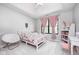 Bright bedroom with a white bed frame, pink curtains, and a large window at 16285 Remington Dr, Fishers, IN 46037