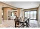 Well-lit dining area with a table set for chess, seamlessly connects to the living room at 16285 Remington Dr, Fishers, IN 46037