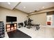 Home gym featuring workout equipment, weights, and a black mat, with bathroom access at 16285 Remington Dr, Fishers, IN 46037