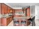 Gourmet kitchen with custom cabinets, granite countertops, and a center island with seating at 16285 Remington Dr, Fishers, IN 46037