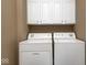 Functional laundry room with a side-by-side washer and dryer, and upper cabinet storage at 16285 Remington Dr, Fishers, IN 46037
