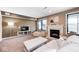 Cozy living room with fireplace, beige sofa, and natural light from large windows at 16285 Remington Dr, Fishers, IN 46037