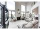 Bright living room with large windows, a cozy fireplace, and comfortable seating at 16285 Remington Dr, Fishers, IN 46037