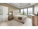Main bedroom with tray ceiling, comfortable king bed and serene lake views at 16285 Remington Dr, Fishers, IN 46037