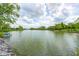 Scenic view of a tranquil pond, offering a peaceful retreat with seating areas along the shoreline at 16285 Remington Dr, Fishers, IN 46037