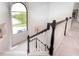 Carpeted stairs with decorative molding lead to a beautiful lake view through a large window at 16285 Remington Dr, Fishers, IN 46037