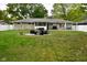 Backyard with patio, fire pit, outdoor furniture, and green grass at 1701 Lincoln Rd, Speedway, IN 46224