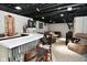 Finished basement with bar area, dart board, and comfortable seating for entertaining at 1701 Lincoln Rd, Speedway, IN 46224