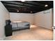 Finished basement bedroom with neutral carpet, and black finished ceiling at 1701 Lincoln Rd, Speedway, IN 46224
