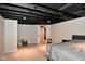 Spacious finished basement bedroom with neutral carpet and drop ceiling at 1701 Lincoln Rd, Speedway, IN 46224