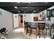 Basement featuring a bar area with seating and a dartboard for entertainment at 1701 Lincoln Rd, Speedway, IN 46224