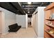 Finished basement with black futon, closet, and bookshelf at 1701 Lincoln Rd, Speedway, IN 46224
