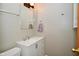 Bathroom with white vanity, chrome fixtures, and an updated mirror and vanity light at 1701 Lincoln Rd, Speedway, IN 46224