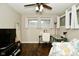 A well-lit bedroom featuring a ceiling fan, large windows, and hardwood floors at 1701 Lincoln Rd, Speedway, IN 46224
