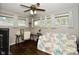 Cozy bedroom featuring a ceiling fan, a desk, and windows allowing natural light at 1701 Lincoln Rd, Speedway, IN 46224