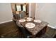 Marble dining table with leather chairs next to an opening into the living room at 1701 Lincoln Rd, Speedway, IN 46224