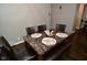 Features a brown marble table with leather chairs in an naturally lit room at 1701 Lincoln Rd, Speedway, IN 46224