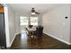 Dining room with dark wood floors, a table set for four, and access to an outdoor patio at 1701 Lincoln Rd, Speedway, IN 46224