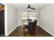 Dining area with modern table and chairs, featuring hardwood floors and neutral wall colors at 1701 Lincoln Rd, Speedway, IN 46224