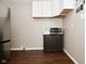 Eat-in kitchen with stainless steel appliances, dark wood floors and white upper cabinets at 1701 Lincoln Rd, Speedway, IN 46224