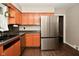 Traditional-style kitchen with stainless steel refrigerator and wooden cabinets at 1701 Lincoln Rd, Speedway, IN 46224