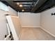Unfinished basement space with neutral carpet and drop ceiling at 1701 Lincoln Rd, Speedway, IN 46224