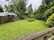 Expansive backyard with green grass, mature trees, and a wooden fence for privacy at 1949 Shenandoah Pl, Indianapolis, IN 46229