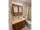 Bathroom vanity with drawers and cabinet, sink, framed mirror, and toilet at 1949 Shenandoah Pl, Indianapolis, IN 46229