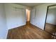 Bedroom with hardwood floors, closet with mirror, and adjacent bathroom at 1949 Shenandoah Pl, Indianapolis, IN 46229