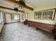Cozy sun room with tile flooring, wood beams, and large windows offering serene backyard views at 1949 Shenandoah Pl, Indianapolis, IN 46229